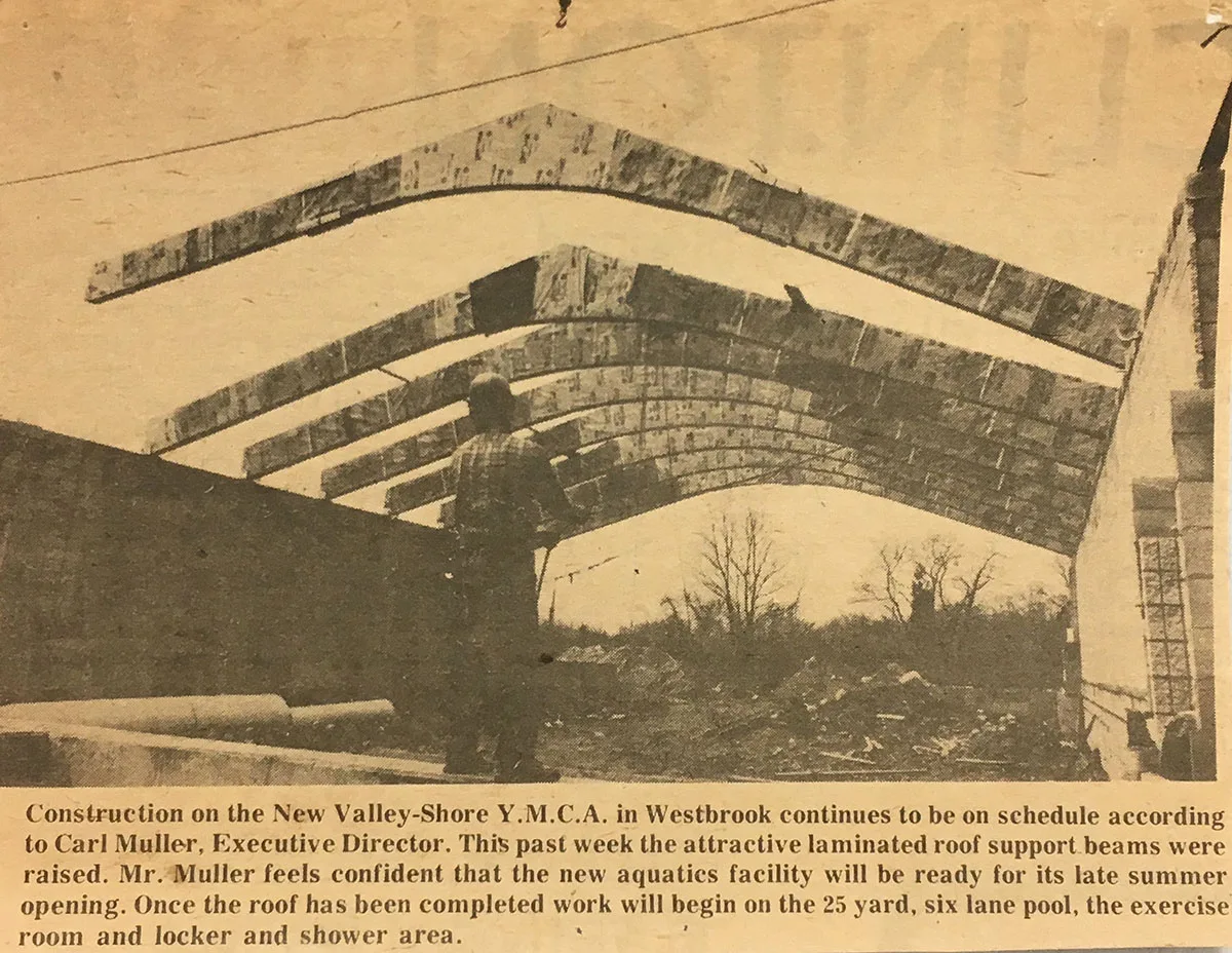 A newspaper clipping from 1975, showing the main support beams for the roof of the Valley-Shore YMCA in Westbrook being installed.