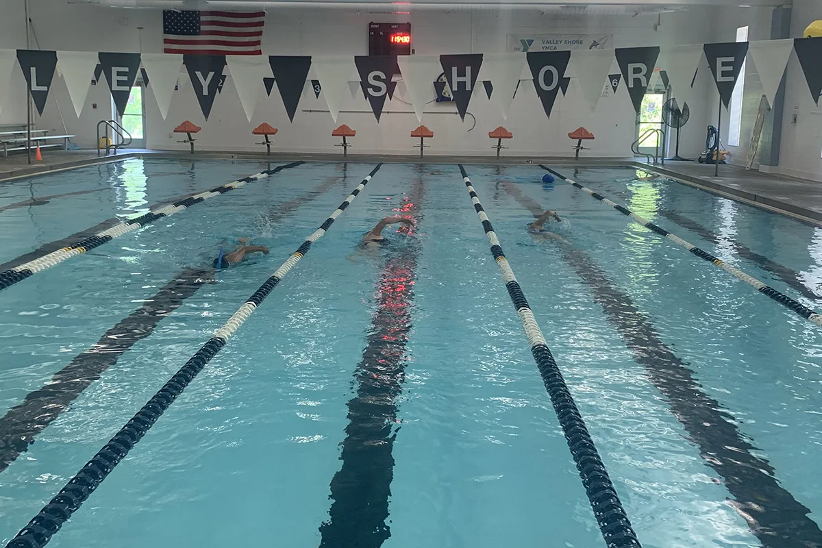 Three swimmers utilize the olympic pool with lanes in Connecticut River Valley at Valley Shore YMCA
